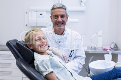 Portrait of smiling dentist and young patient