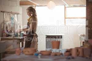 Beautiful female potter molding clay