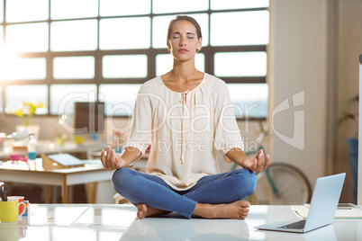 Business executive performing yoga