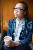 Female doctor having tea in clinic