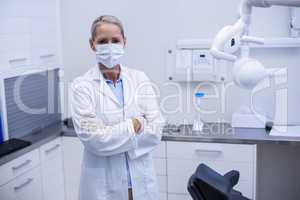 Female dentist standing with arms crossed