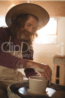 Male potter making pot