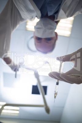 Female dentist holding syringe