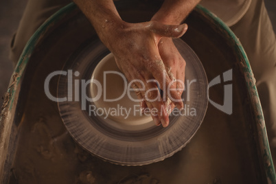 Male potter making pot