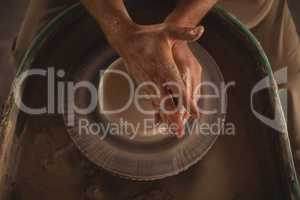 Male potter making pot