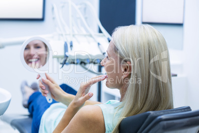 Female patient looking at mirror