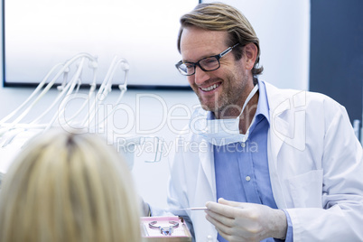 Dentist examining a woman with tools