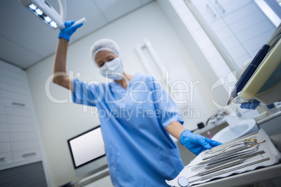 Dental assistant holding tray with equipment