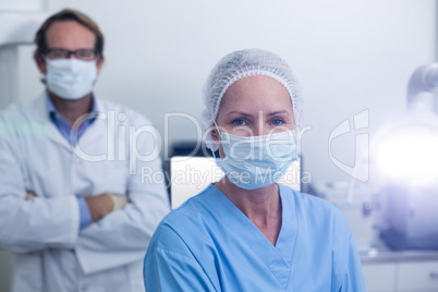 Portrait of dentist and dental assistant wearing surgical mask