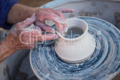 Close-up of potter making pot