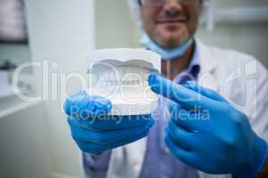 Dentist holding a mouth model