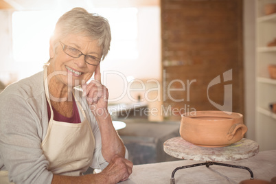 Female potter sitting at table