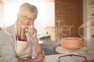 Female potter sitting at table