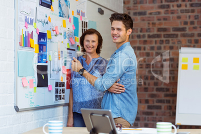 Business people standing near whiteboard