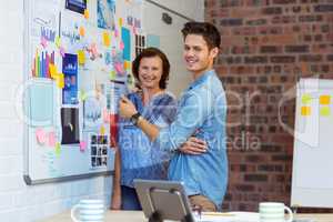 Business people standing near whiteboard