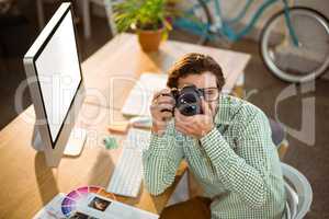 Graphic designer clicking photo from digital camera