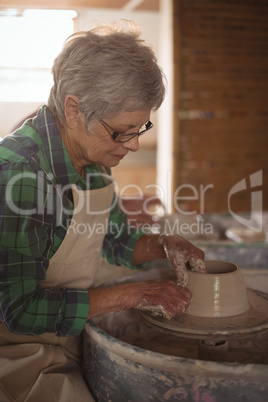 Female potter making a pot