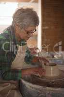 Female potter making a pot