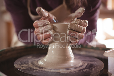 Male potter making pot