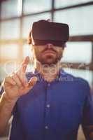 Male business executive using virtual reality headset