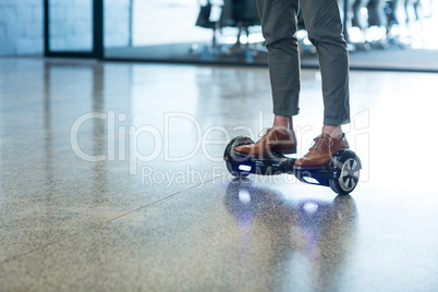 Graphic designer standing on hoverboard