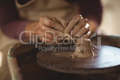 Close-up of potter working on bowl