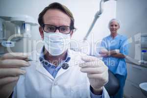 Dentist holding dental tools