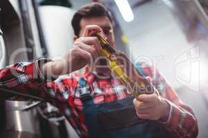 Manufacturer examining beer bottle at brewery