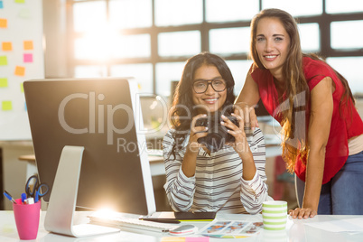 Business executives checking photos in camera