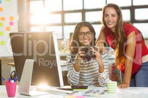 Business executives checking photos in camera