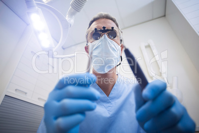 Dental assistant holding dental tool
