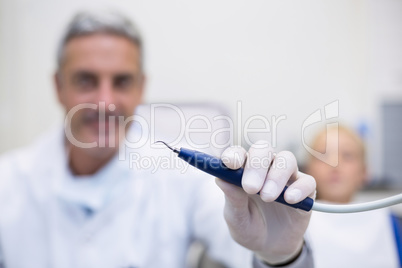 Dentist holding dental tool