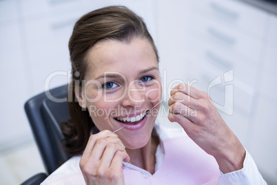 Female patient flossing her teeth