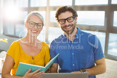 Business executives holding document and laptop