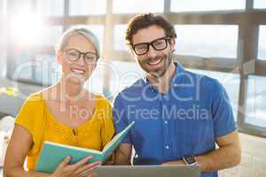 Business executives holding document and laptop