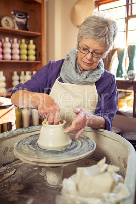 Female potter making pot