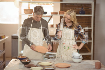 Potters checking plates and bowl