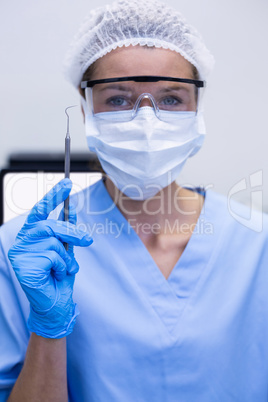 Dental assistant holding dental tool