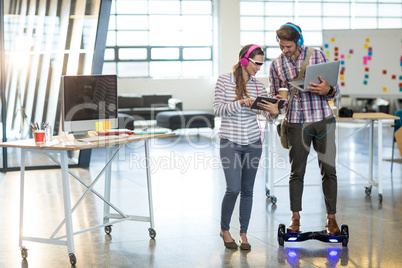 Colleagues using digital tablet and laptop