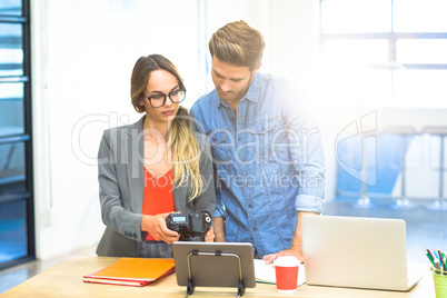 Business executives checking photos in camera