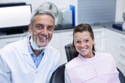 Portrait of smiling dentist and young patient