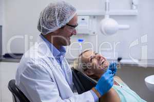 Male dentist interacting with female patient