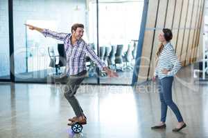 Graphic designer standing on hoverboard