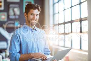 Male business executive using laptop