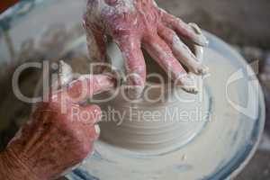 Close-up of potter making pot