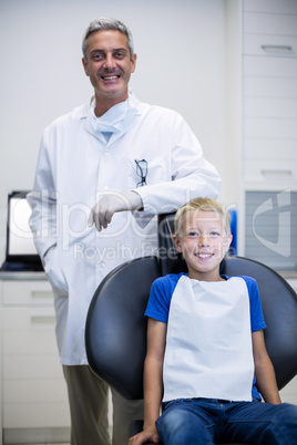 Portrait of smiling dentist and young patient