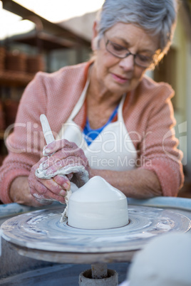 Female potter making pot