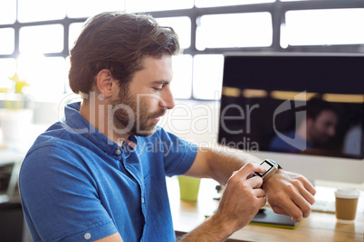 Business executive adjusting a smartwatch