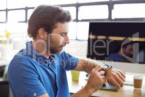 Business executive adjusting a smartwatch