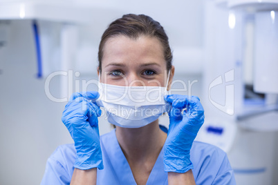 Dental assistant wearing surgical mask in dental clinic